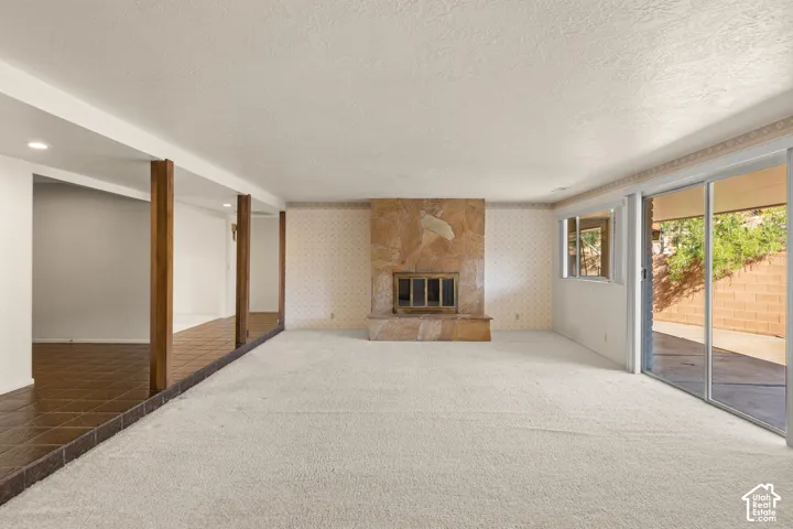 Expansive living area with a stone fireplace and hearth