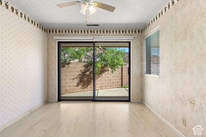 Light wood-finish flooring with a ceiling fan