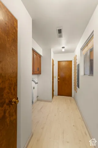Light wood-finish flooring with white walls