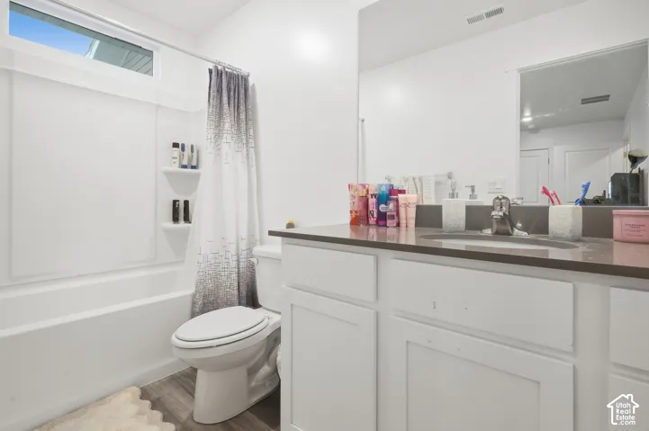 White vanity with a neutral countertop and integrated sink