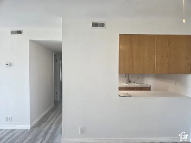 LVP flooring, white walls, and a pass-through window with a countertop