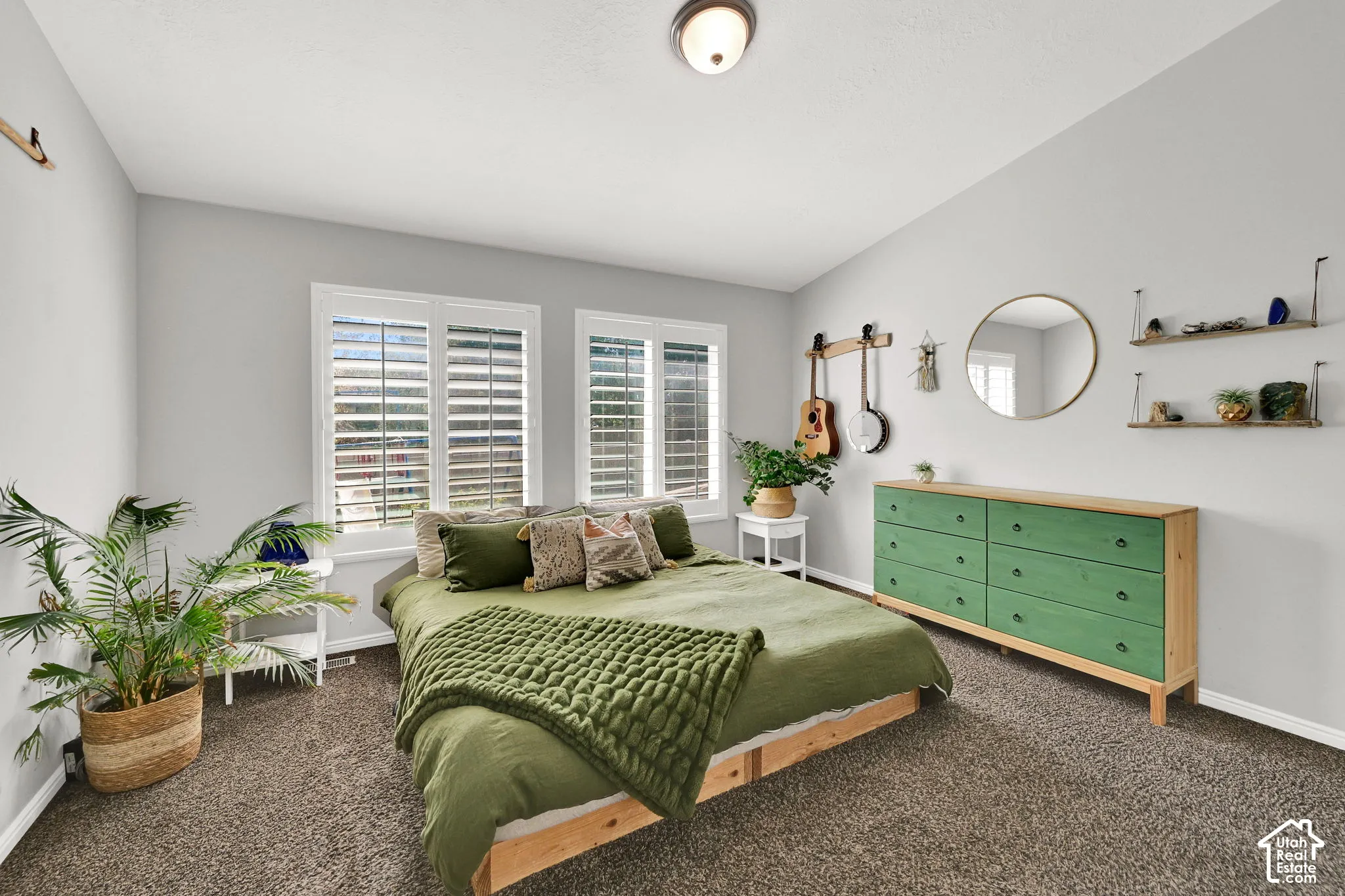 Two double-hung windows with white plantation shutters