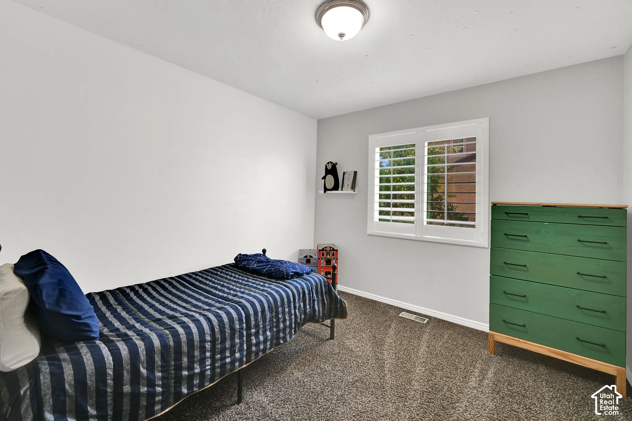 Recessed window with white plantation shutters