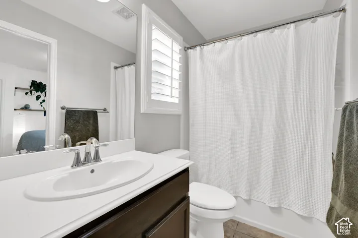 Vanity with an integrated sink, polished chrome faucet, wood-finish cabinetry, and a full-width mirror