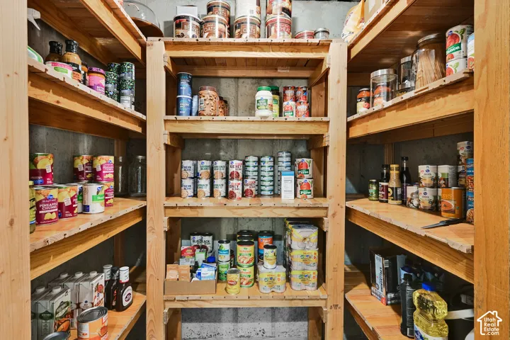 Storage area featuring extensive wood shelving units