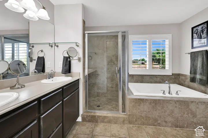 Dual vanity with integrated sinks, a built-in soaking tub, and a separate glass-enclosed shower