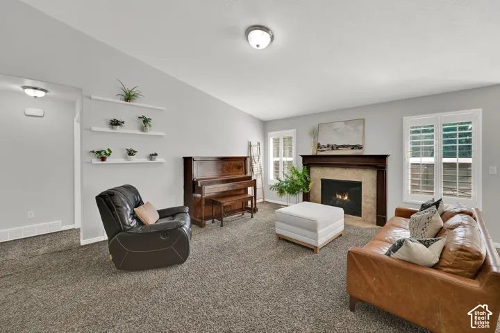 Recessed fireplace with a dark wood mantel and stone surround