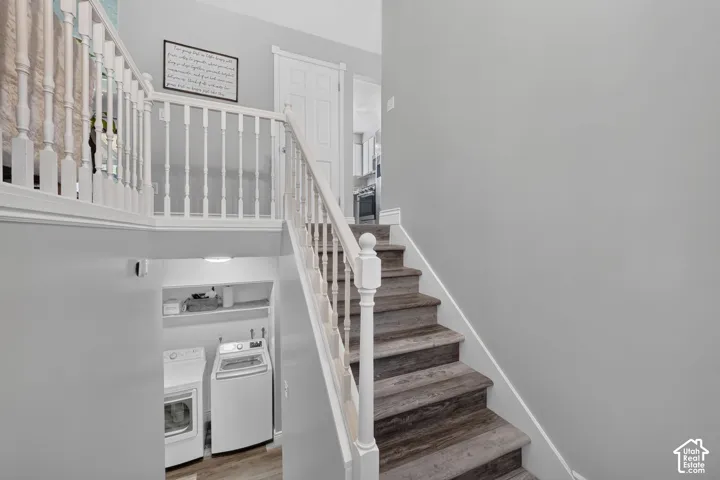 Staircase featuring wood-finish treads and white balusters
