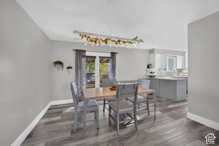 Wood-finish flooring throughout, with a recessed ceiling and white baseboards
