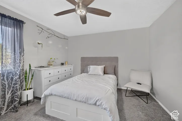 Wall-to-wall carpeting and a ceiling fan with integrated lighting