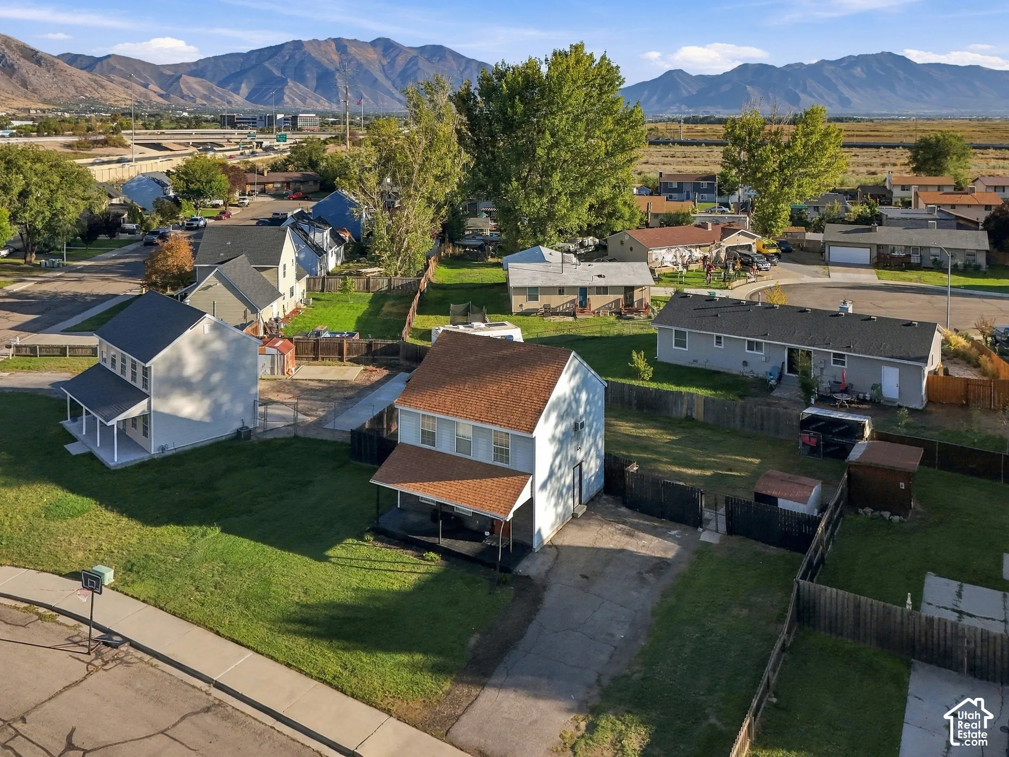 Two-story residential property featuring a covered front porch, a two-story structure, and a fenced backyard