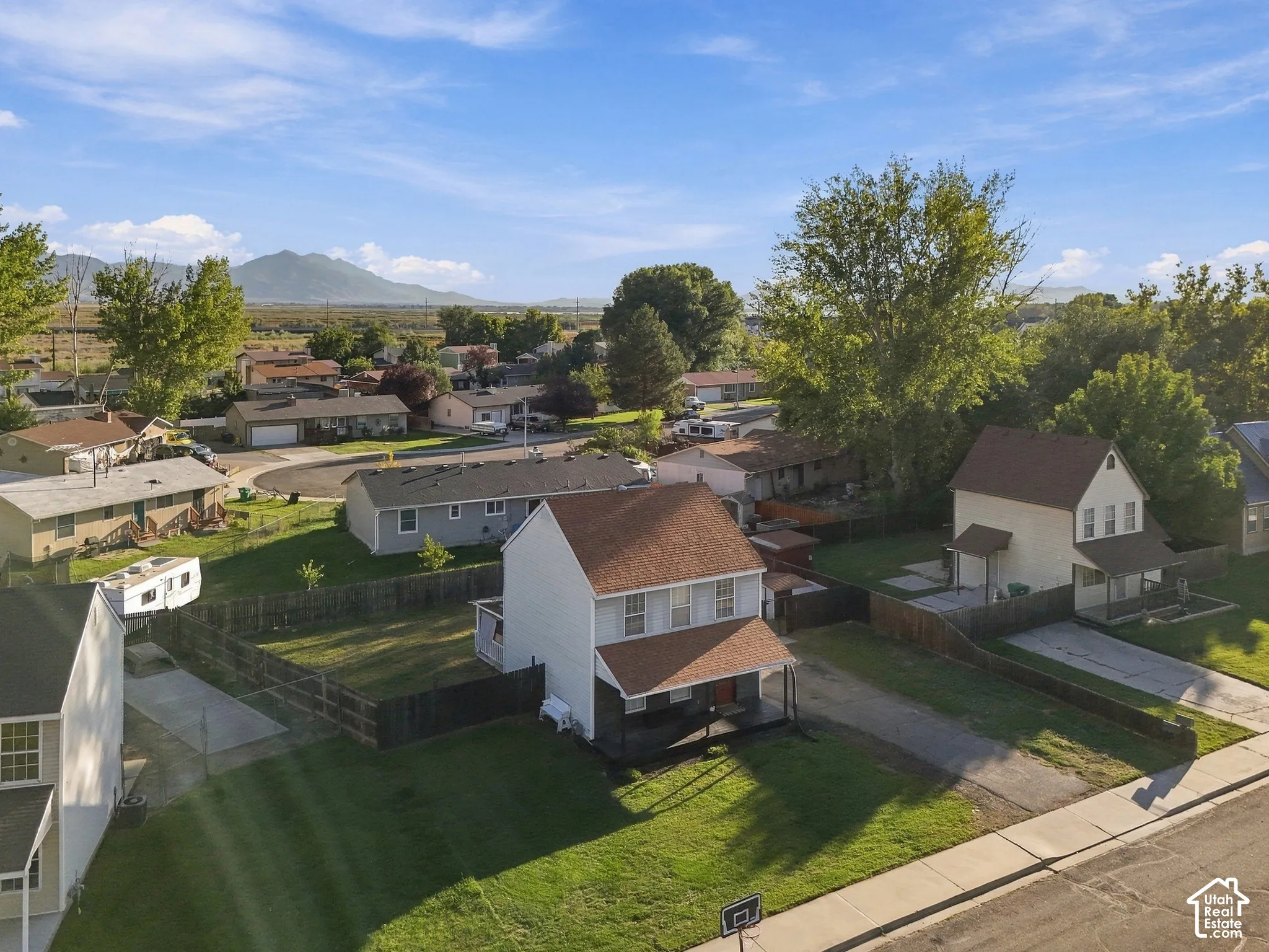 Two-story residence with a covered porch and fenced backyard