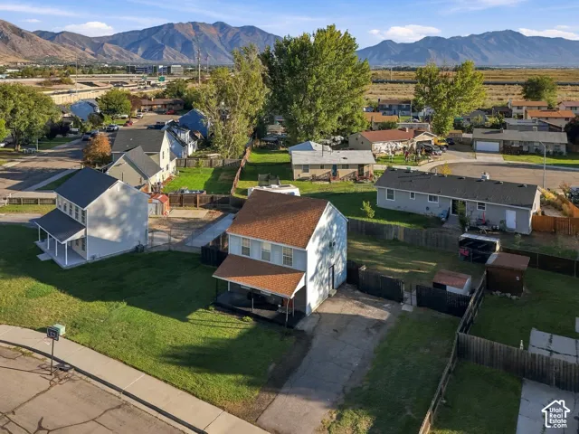Two-story residential property featuring a covered front porch, a two-story structure, and a fenced backyard