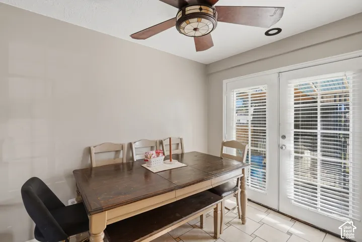Recessed lighting, ceiling fan with integrated light, double French doors, window blinds, and tiled flooring