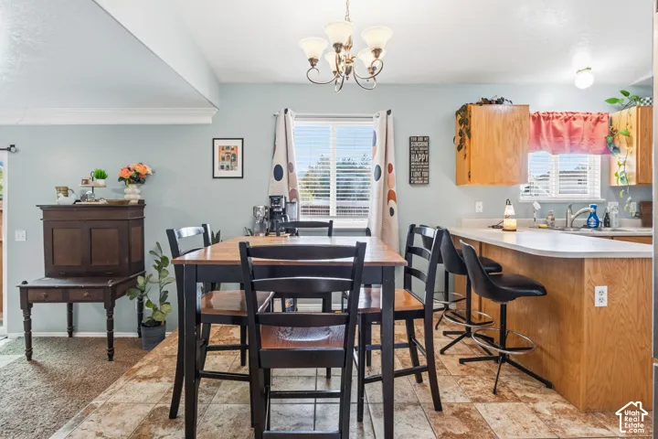 Kitchen with wood-finish flooring, oak cabinetry, and light-toned countertops