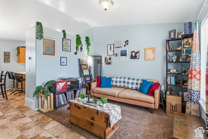 Living area with light blue walls and textured carpeting