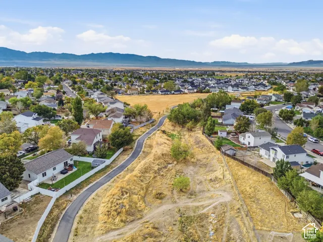 Residential neighborhood with established homes, paved streets, and distant mountain scenery