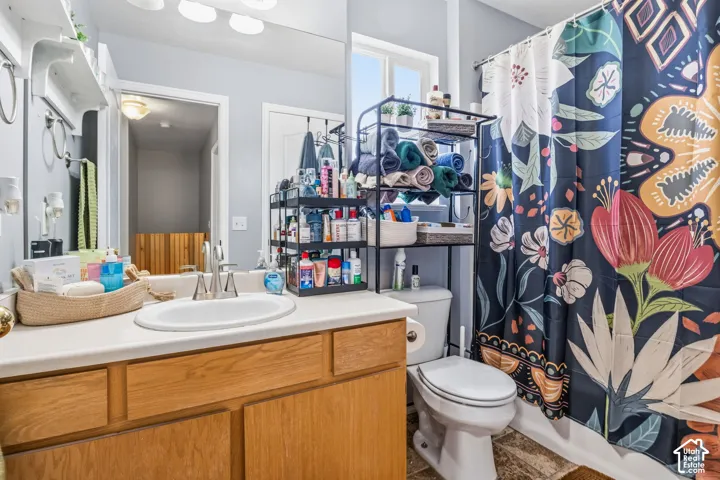 Single vanity with a white countertop and natural wood-finish cabinetry