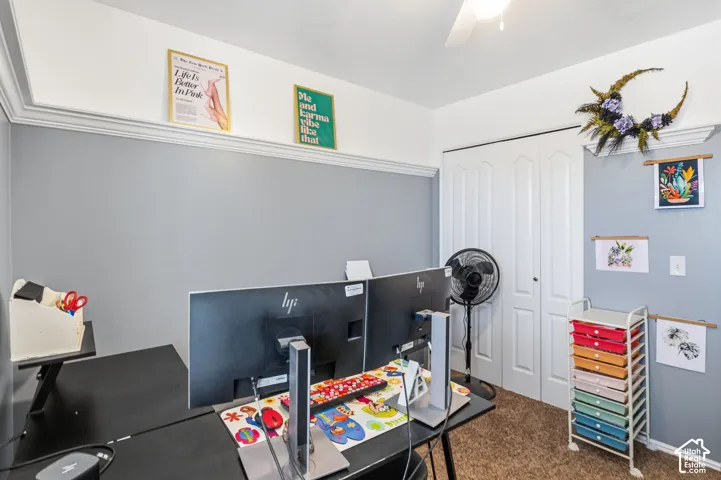 White crown molding, neutral wall color, white ceiling fan, and bi-fold closet doors