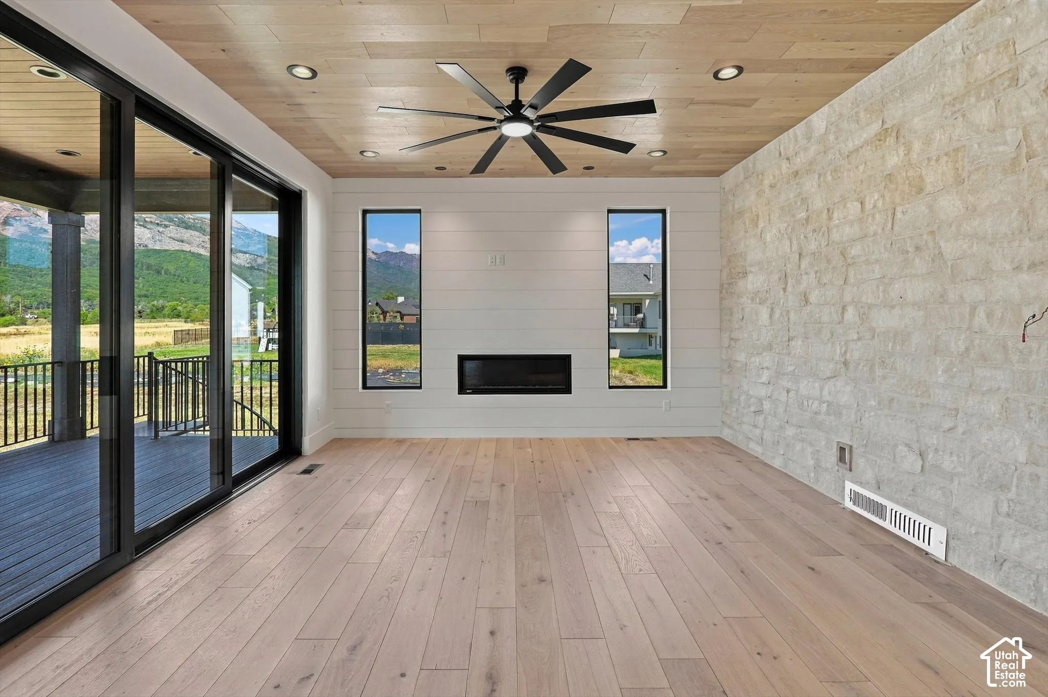 Wood-finish flooring with a wood-panel ceiling and recessed lighting