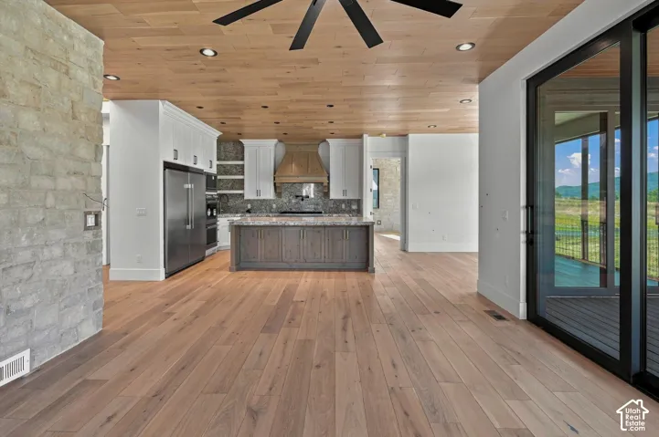 Wood-finish flooring throughout, with a wood-paneled ceiling and recessed lighting