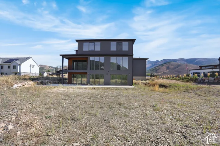 Modern multi-story property with a dark-toned exterior and expansive window placement