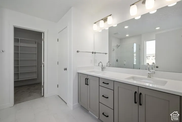 Dual vanity with undermount sinks, stone-finish countertop, and integrated mirror