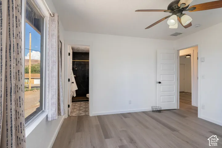 Light wood-finish flooring with white walls