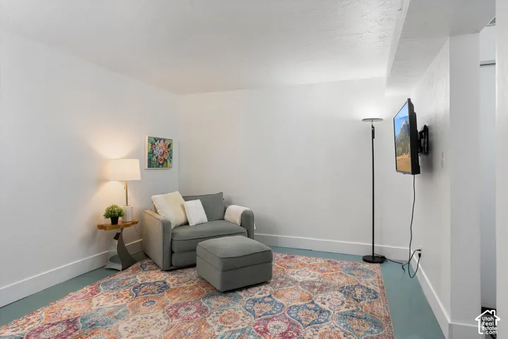 Painted concrete flooring, white walls, and bright overhead lighting