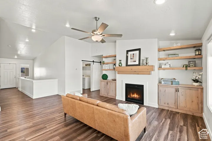 Wood-finish flooring throughout, vaulted ceiling, and recessed lighting