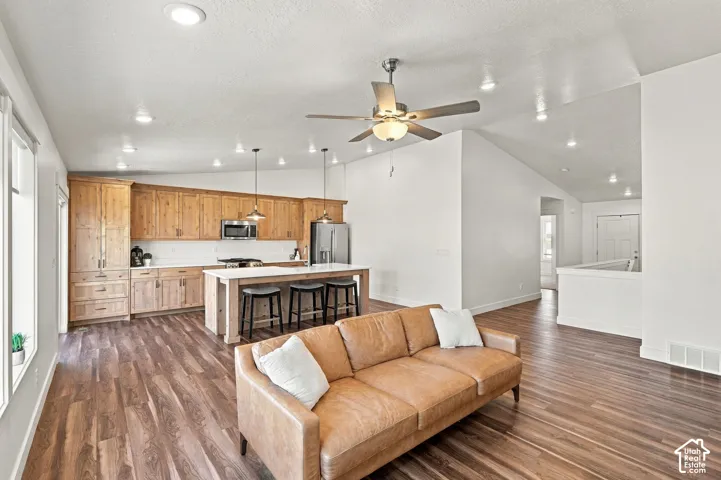Vaulted ceiling with recessed lighting and a ceiling fan