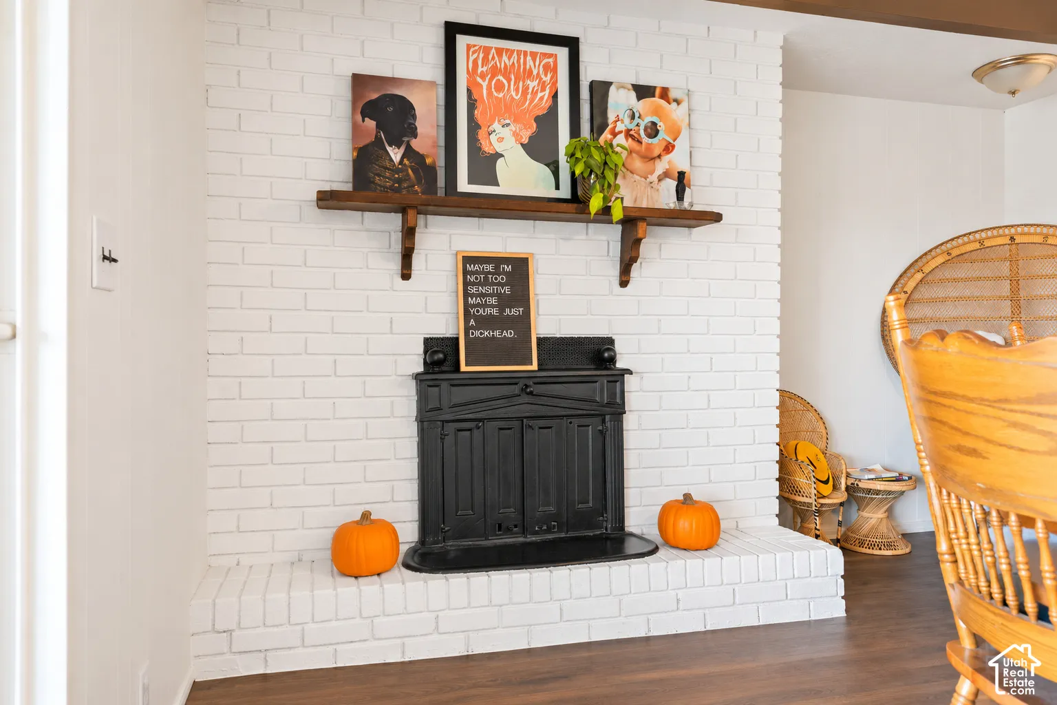 Brick fireplace with a wood mantel, black firebox, and a hearth