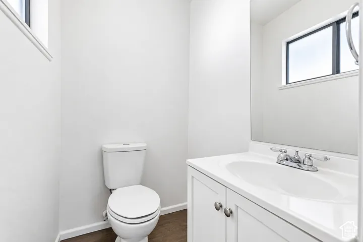 White vanity with an integrated sink and chrome faucet, set against a large wall-mounted mirror