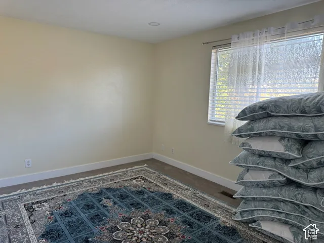 Recessed ceiling lighting, light-toned walls, and window with blinds