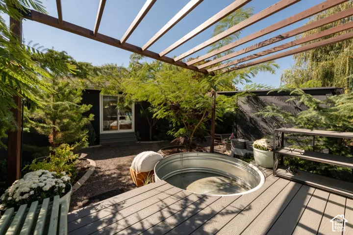 Wood pergola structure over a composite deck