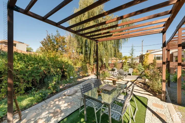 Pergola structure over a patio with stone paving