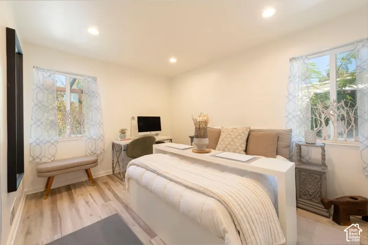 Recessed lighting illuminates wood-finish flooring
