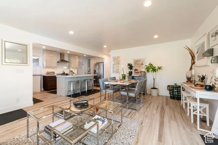 Open-concept living space with light wood-finish flooring