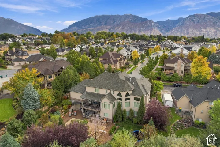 Expansive property featuring a multi-story exterior, arched windows, and a large outdoor patio area