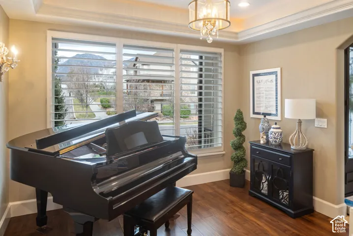 Recessed ceiling with crown molding and a decorative chandelier