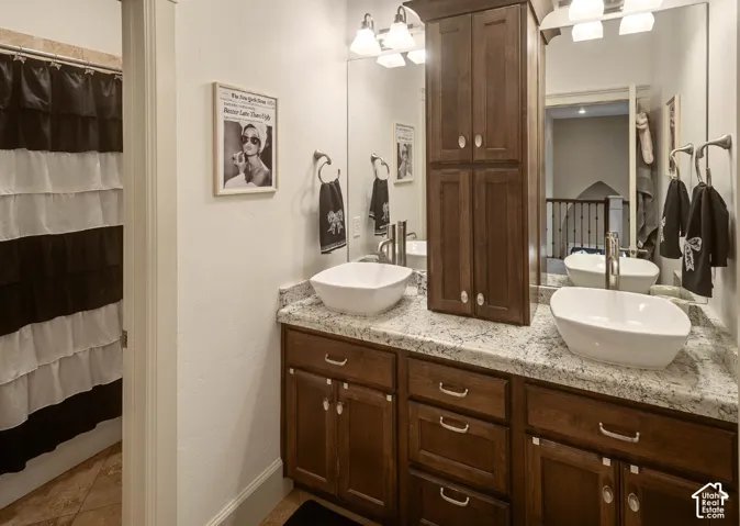 Dual vessel sinks with brushed nickel fixtures, set on a light-toned countertop