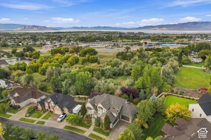 Expansive property with mature trees, verdant landscaping, and a manicured lawn
