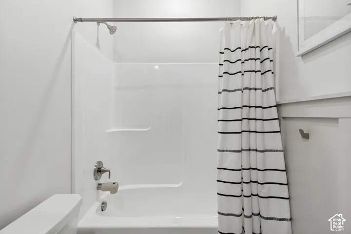 White shower/tub combination with brushed nickel fixtures