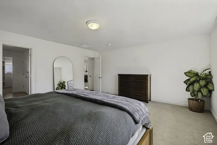 Recessed lighting, light-toned carpet, and a white interior paint palette