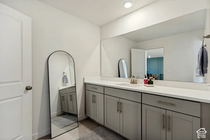 Dual vanity with integrated sink, expansive countertop, and built-in cabinetry