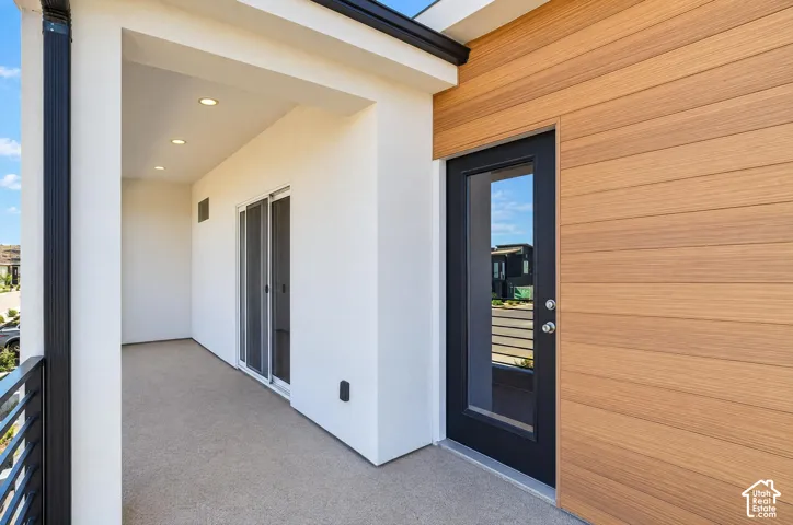 Outdoor balcony with textured flooring and recessed lighting