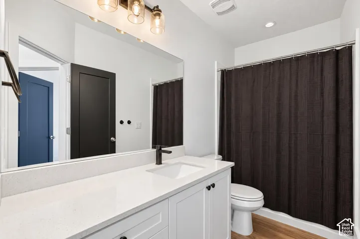 White vanity with black hardware, integrated sink, and white countertop