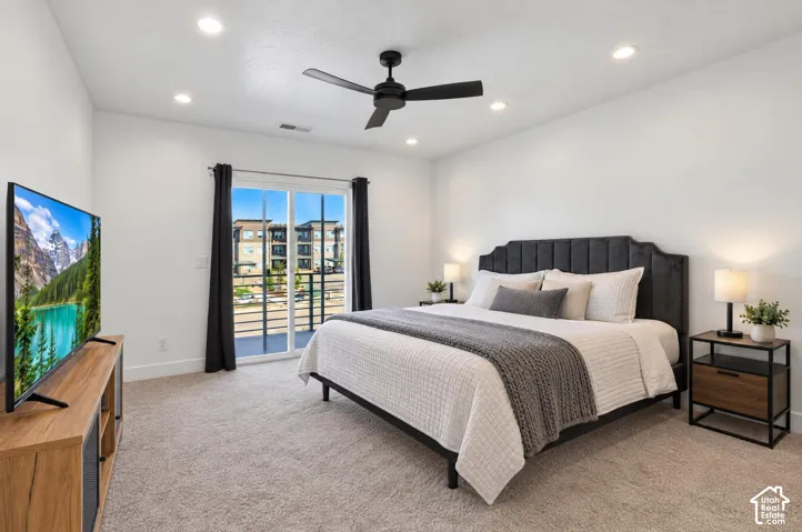 Recessed lighting, ceiling fan, sliding glass door to a balcony, and carpeted flooring