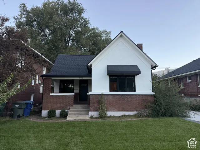Brick and stucco exterior with dark roofing
