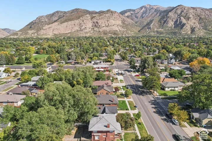 Mountain backdrop, tree-lined streets, residential neighborhood, established landscaping, wide roadways